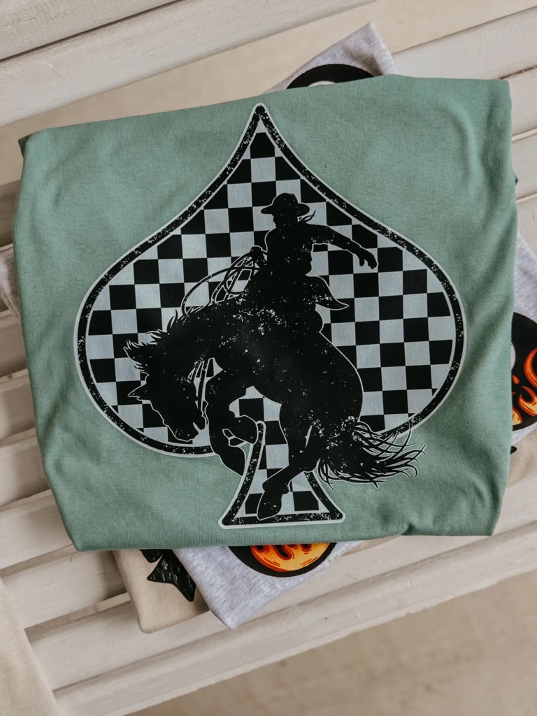Aquatic Bucking Spade T-shirt featuring a checkerboard spade and bucking bronco cowboy graphic.