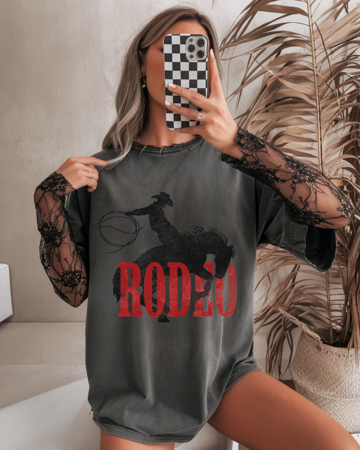 Charcoal Comfort Colors Rodeo T-shirt with red RODEO lettering and black bucking bronco graphic.